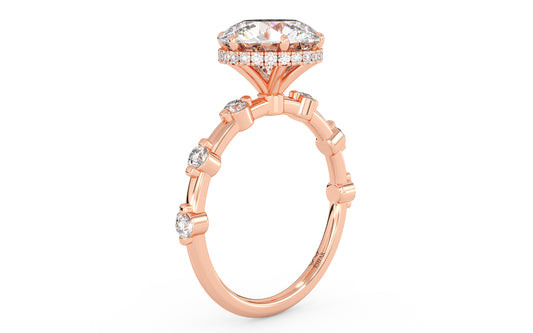 A rose gold ring with sparkling round diamonds in a double gallery setting. Custom fit for your center stone, blending timeless elegance and contemporary charm. 