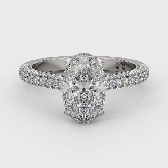 Customizable golden engagement ring with a hidden halo, round brilliant diamonds, and a maxed diamond band for added brilliance and elegance. 